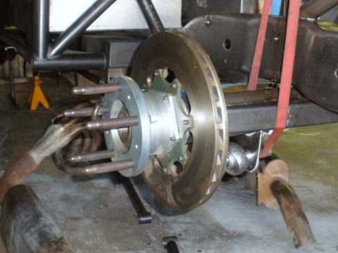 2008 Ford Bronco - Close-up view of a vehicle's disc brake assembly, a custom hub and exhaust components.