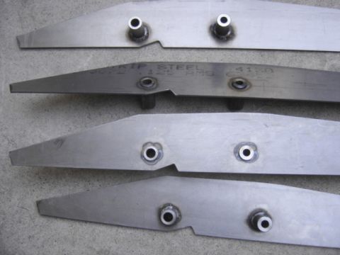 2008 Ford Bronco - Close-up of four metal brackets, one of which is marked with 'CRIP STEEL 125 RMS 4150'.