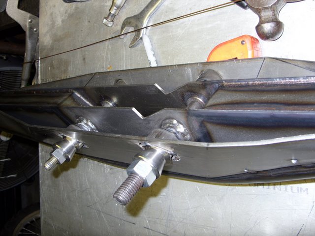 Custom metal fabrication with bolts and welds, viewed from below