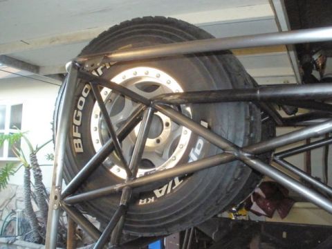 2008 Ford Bronco - A spare tire is secured within a custom roll cage, showing BFGoodrich tire branding.