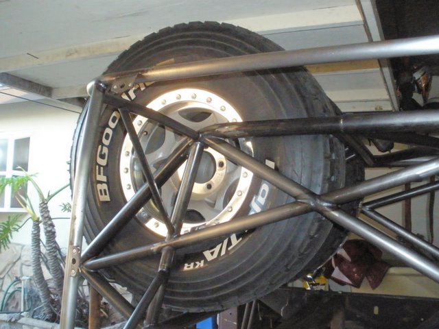 Spare tire mounted in a roll cage with BFGoodrich lettering