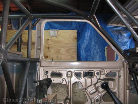 1990 Ford Bronco - Photo of a bare door shell and roll cage tubing on a project vehicle, not a technical document.