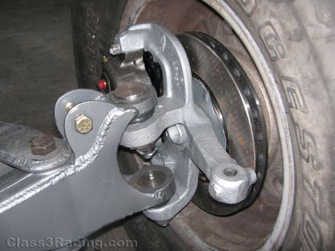 1990 Ford Bronco - Photo of a refurbished front spindle, caliper and rotor on a vehicle, not a technical document.