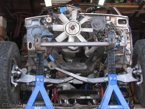 1990 Ford Bronco - Photo of a truck front end on jack stands with cooling fan and suspension, not a technical document.