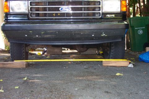 1989 Ford Bronco - The rear of a dark Ford Bronco is visible, parked on a paved surface.