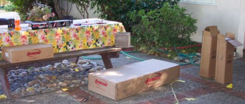1989 Ford Bronco - Several boxes with the Rancho logo are visible on a picnic table and the ground, suggesting parts or equipment.