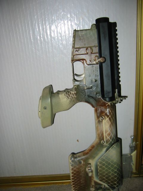 1996 Ford Bronco - A close-up, side view of a custom painted AR-15 style rifle with a camouflage pattern.