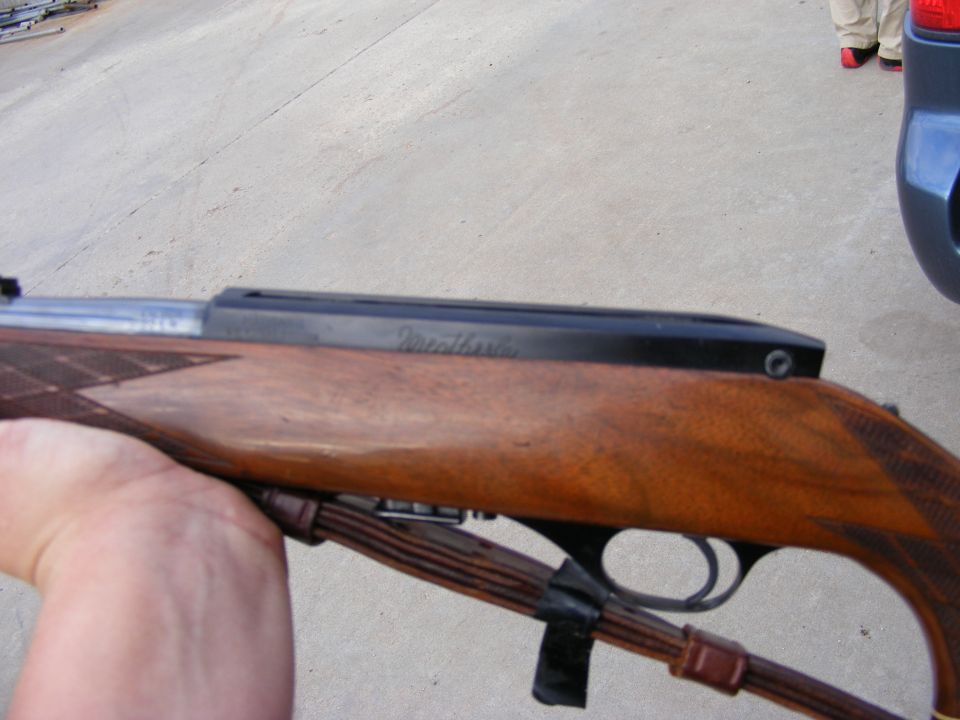 Close-up of a Weatherby rifle with a wooden stock.