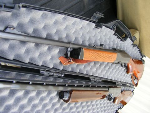 1979 Ford Bronco - Two shotguns are stored in a black foam-lined gun case.