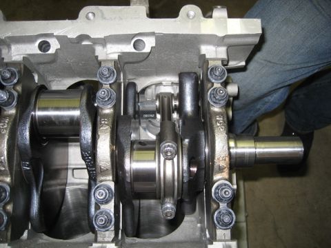 2007 Ford Mustang - Photograph of an engine crankshaft and rods inside the block, not a technical document.