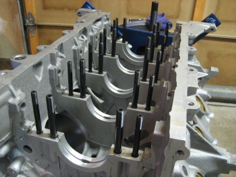 2007 Ford Mustang - Photograph of a bare engine block with installed studs, not a technical document.