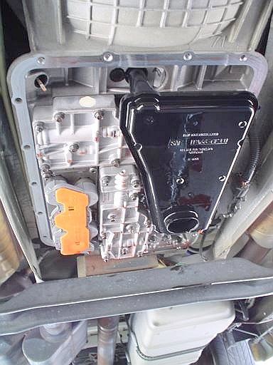 2007 Ford Mustang - Underbody photograph of a transmission valve body and pan, not a technical document.