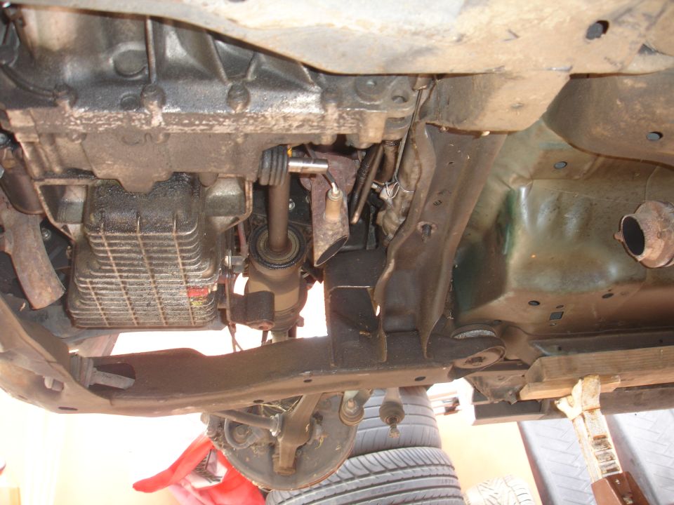 Photo of a vehicle undercarriage with transmission and oil pan