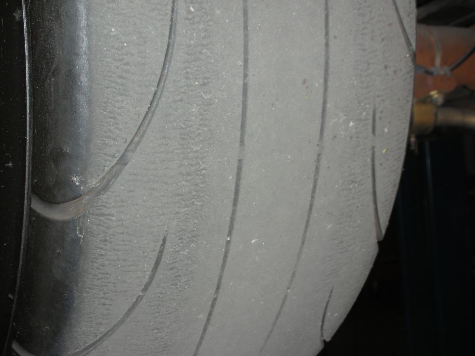 Close-up of a worn tire tread on a vehicle.