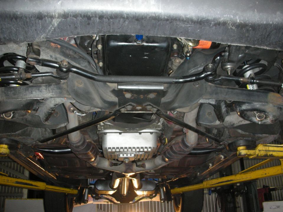 Undercarriage of a 1992 Ford Crown Victoria showing suspension and exhaust.