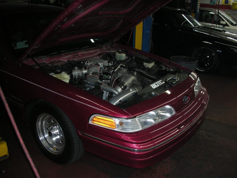 Maroon 1992 Ford Crown Victoria engine bay with aftermarket turbocharger