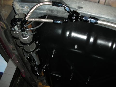 1992 Ford Crown Victoria - Underside view of a vehicle's fuel system, showing dual filters and fuel tank.