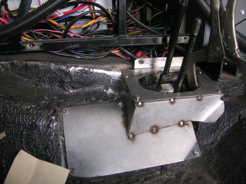 1996 Ford Bronco - A close-up view of a custom-fabricated shifter console and extensive wiring harness within a vehicle's interior.