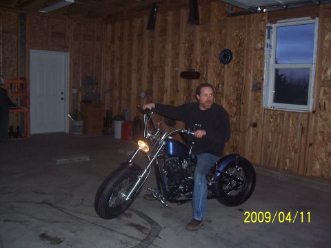 1988 Suzuki Samurai - A man sits on a custom blue motorcycle inside a garage, with a date stamp of 2009/04/11 visible.