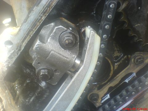 1992 Ford Crown Victoria - Close-up of an engine's timing chain and tensioner mechanism.