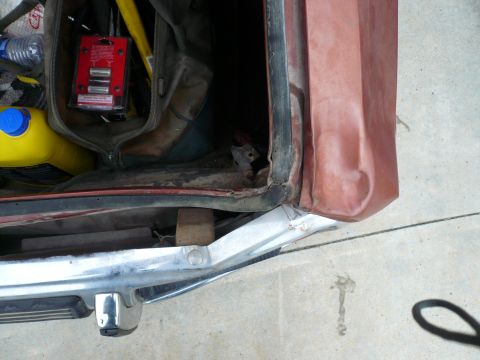 1975 Ford Ranchero - Interior of a car trunk with various items, including tools and a yellow container.
