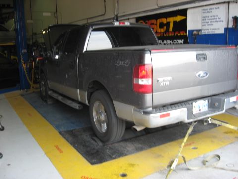 2003 Ford Crown Victoria - Ford F-150 XTR truck undergoing testing on a dynamometer in a workshop.