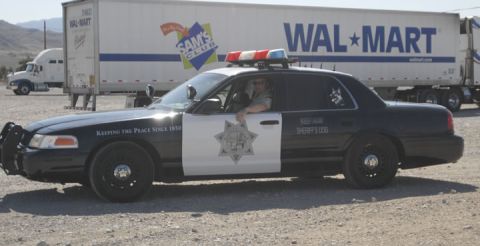 1991 Ford LTD Crown Victoria - A 1991 Ford Crown Victoria LTD police car is parked in front of a Walmart trailer.
