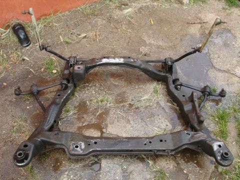 1995 Ford Taurus - This is a removed front subframe assembly, likely from a car, showing suspension linkage components.