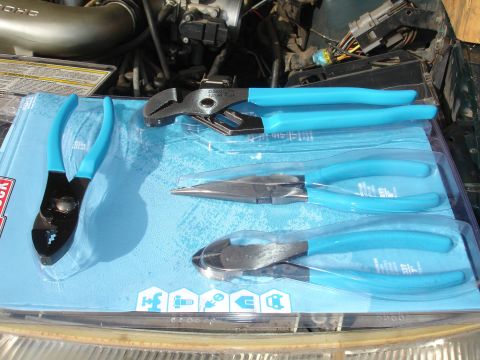 1995 Ford Taurus - A set of blue-handled pliers, including slip-joint, needle-nose, and diagonal cutters, are displayed on a blue backing card.