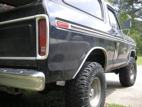 1979 Ford Bronco - Rear view of a black 1978 Ford Bronco, showing its distinctive body style and off-road tires.