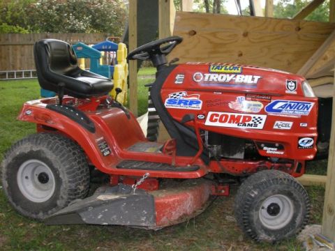 1979 Ford Bronco - This red riding mower is covered in various racing stickers and decals.