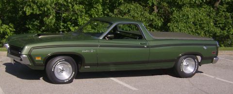 1971 Ford Ranchero - This green Ford Ranchero is parked outdoors with trees in the background and a SuperMotors watermark.