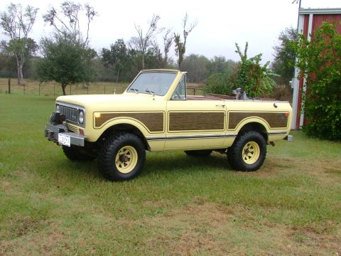 1975 International Scout II - This 1975 International Scout II features a distinctive yellow exterior with wood paneling accents and an open-top design.
