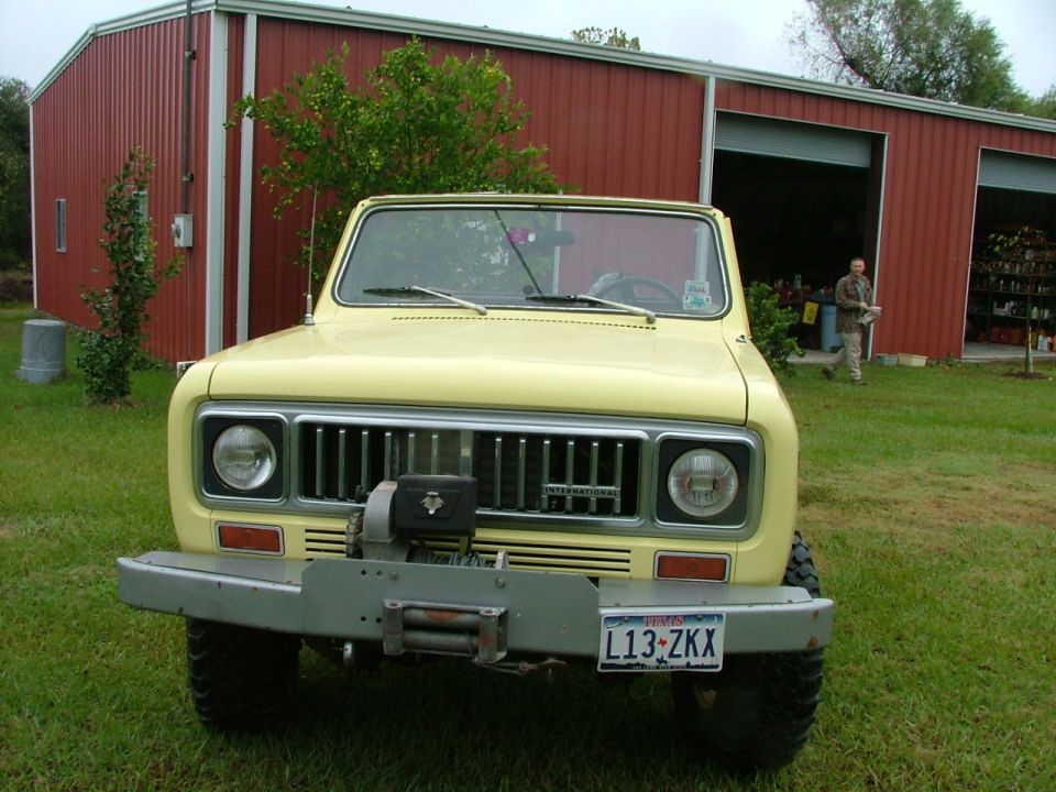 Yellow International Harvester Scout SUV front view with winch and brush guard