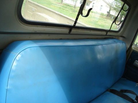1975 International Scout II - Interior view of a vehicle's bench seat and the view through the rear window.