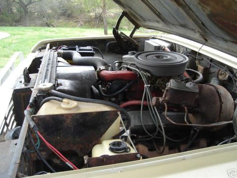1975 International Scout II - The engine bay of a vehicle, a V8 engine, radiator, and air cleaner assembly.