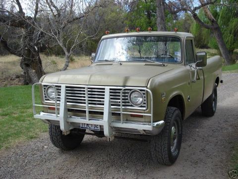1975 International Scout II - This 1975 International Scout II pickup truck is parked on a gravel road with trees in the background.