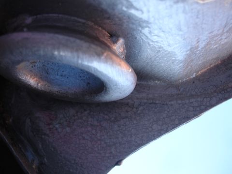 1995 Ford Taurus - A close-up view of a metal loop and textured surface, possibly a vehicle part, against a clear sky.