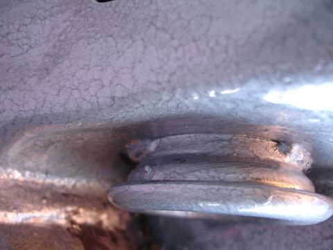 1995 Ford Taurus - Detail of a vehicle's suspension part, showing a worn and cracked surface texture.