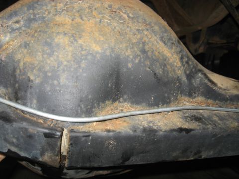 1978 Ford Bronco - Rear axle housing shows significant rust and wear, with a brake line visible.