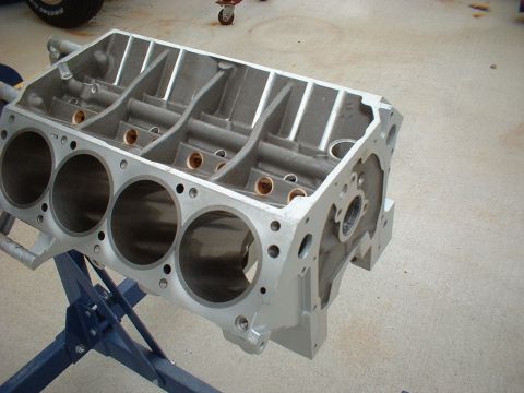 1969 Mercury Cyclone - An aluminum engine block is shown on a blue stand, ready for assembly or inspection.