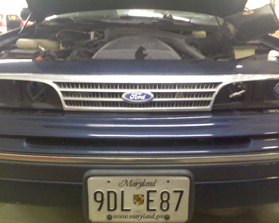Front of dark blue Ford Crown Victoria with hood open, Maryland plate 9DL E87