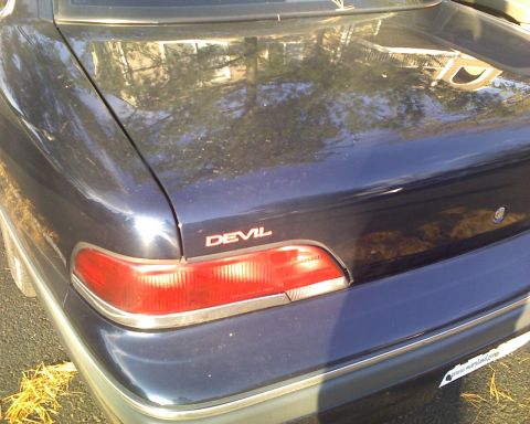 1993 Ford Crown Victoria - she finally got her name badge. Cut the "LE" off the end of a "Deville" emblem at work, scuffed up the chrome, painted red.