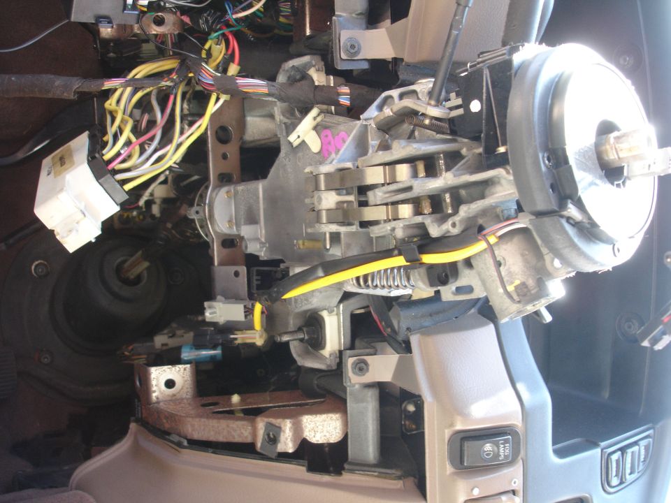 Photo of a steering column installed in a dashboard with wiring