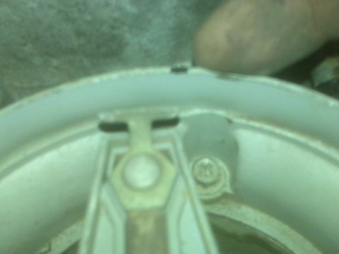 1995 Ford Bronco - A close-up, slightly blurry view of the inside of a distributor cap, showing the rotor arm and some internal components. A person's thumb i…