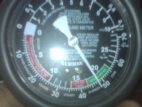 1995 Ford Bronco - A close-up shot of a vacuum meter gauge, likely for a vehicle, with readings and text indicating engine conditions.