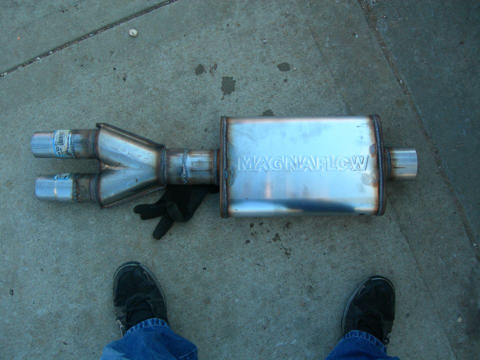 Magnaflow exhaust muffler with dual inlet Y-pipe, lying on concrete