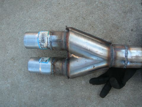 1984 Ford Bronco - A close-up view of a newly welded exhaust y-pipe, showing the merging of two pipes into one.