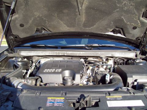 1999 Mercury Grand Marquis - The open hood reveals the engine bay of a vehicle, featuring a black engine cover with "3500 V6" text. The surrounding components and wirin…