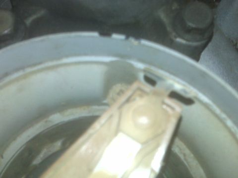 1995 Ford Bronco - A close-up, slightly blurry view of the inside of a distributor cap, showing the rotor arm and internal components. The cap appears to be m…